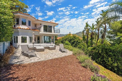 Spacious patio with outdoor seating and beautiful hillside views.