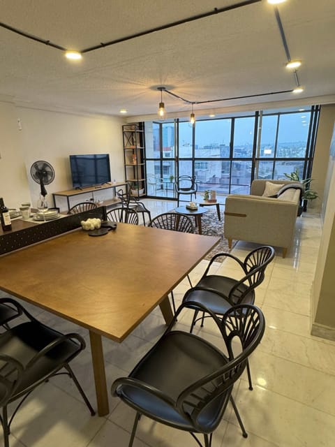 Host family meals or group gatherings around this elegant dining table with impressive city views.
