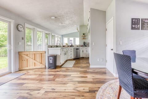 The bright kitchen comes fully equipped with stainless steel appliances, plenty of culinary tools, a small television and counter bar area