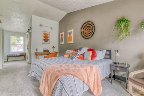 The primary bedroom has a king bed, large flat-screen TV, backyard access, desk space, and a private ensuite