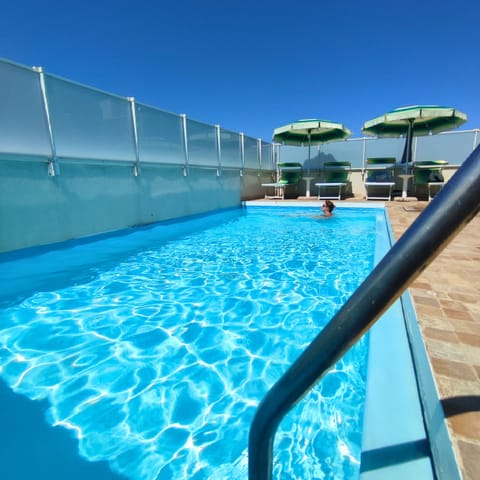 Outdoor pool, pool umbrellas, sun loungers