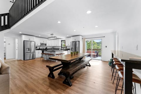 Open dining/kitchen space with seating for 18 at bars and dining table