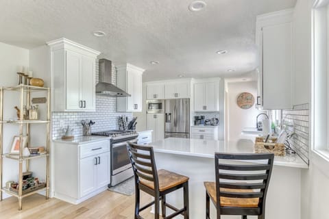 Cook up a storm in this bright, white kitchen! Modern appliances and a stylish island make meal prep a breeze.