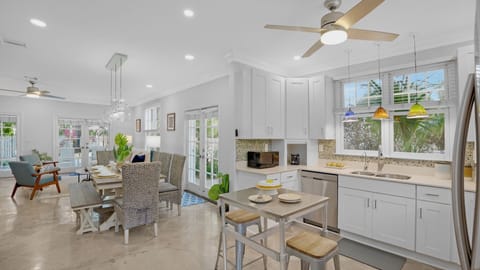 The living room, dining room, and kitchen flow as one space...