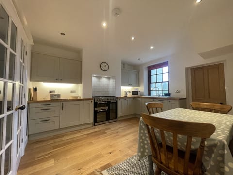 The kitchen boasts an impressive gas cooking range, dishwasher and microwave