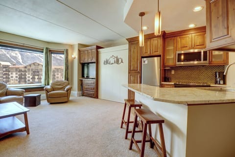 Open concept living and kitchen area, barstool seating at the island.