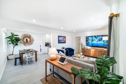 View from the front door. The open-concept living area blends the living room, dining room, and kitchen with beach decor