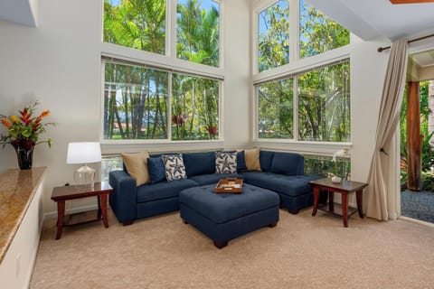 - Relax on a navy blue sectional surrounded by walls of windows and tropical greenery - Natural light pours into this bright, cozy corner lounge with stylish throw pillows - Enjoy a peaceful view of palms while unwinding indoors with your group