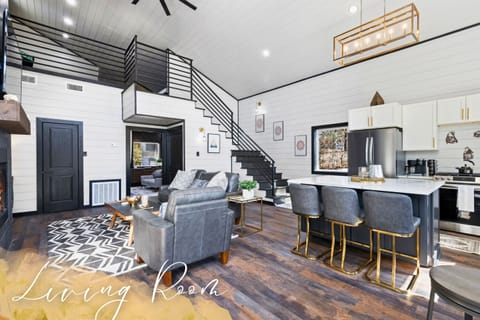 Our living room, featuring a cozy loft and elegant interiors, is the ideal place to unwind and gather.