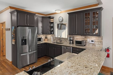 Fully Stocked kitchen with range, toaster oven, coffeemakers, microwave.