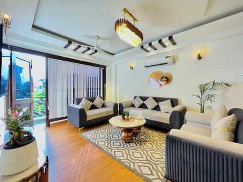 Premium Apartment | Living area | 55-inch LED TV with satellite channels