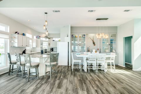 The living area leads to the adjacent dining table and kitchen