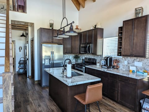 Kitchen has granite counters, large sink and new stainless steel appliances.