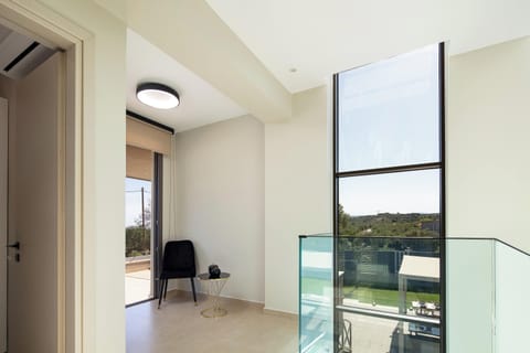 Enjoy the natural lighting coming within the floor-to-ceiling widows