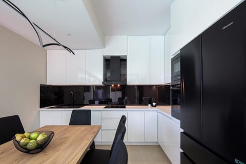 Fully equipped kitchen features a dining table that can seat up to 8 guests