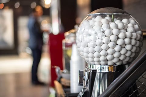 Welcome to a playful lobby, greeted by whimsical gumball machine.