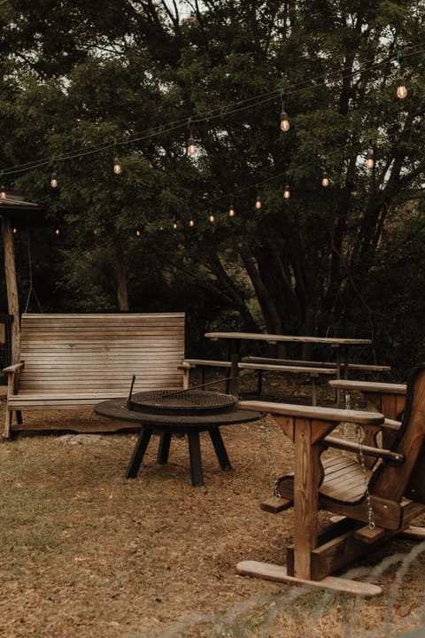 The outdoor space, equipped with chairs, tables, fire pit, and a Black Stone.