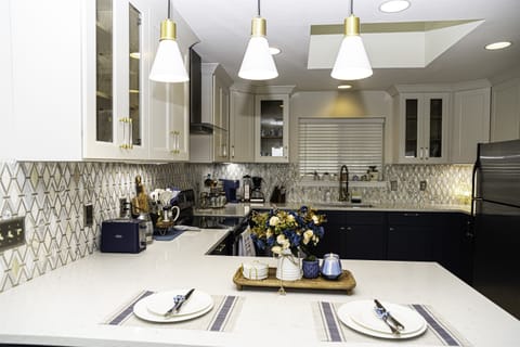  Whether gathered around the table for a formal dinner or enjoying a casual breakfast at the island, the kitchen seamlessly blends with the dining area, creating a cohesive and inviting space for entertaining.