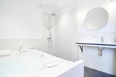 Suite, 1 King Bed, Jetted Tub | Bathroom | Hair dryer, bathrobes, towels