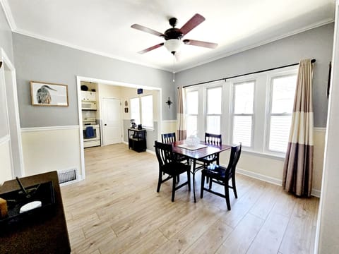 Formal dining room with large, bright windows