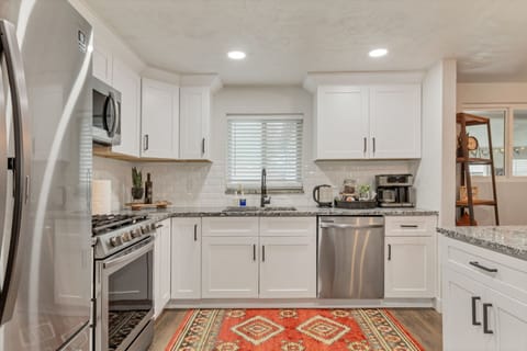 Kitchen is equipped with ample cupboards and cabinets