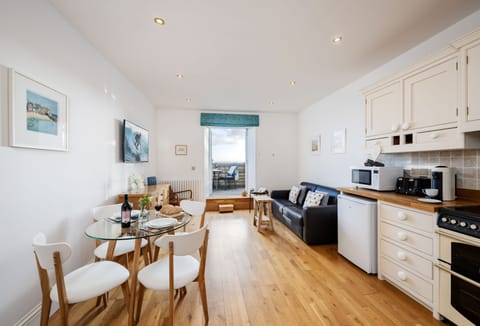 4 Fernhill, Carbis Bay: The bright open-plan living area is a delight, with a comfortable leather sofa, armchair and doors leading to your balcony with sea views