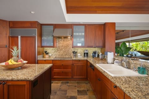 Gourmet modern kitchen fully equipped with top tier appliances.