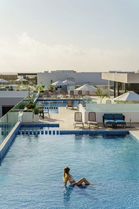 4 outdoor pools, open 9:00 AM to 10:00 PM, pool umbrellas, sun loungers