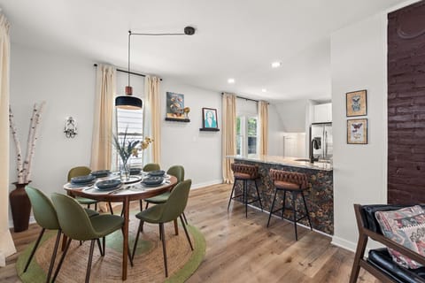Gather `round the table in this chic dining room with warm hardwood floors and cozy vibes. 🍽️ Who`s ready for a delightful meal? #HomeSweetHome