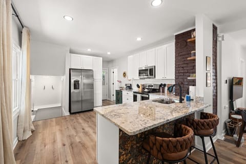 Crisp white cabinets and warm hardwood floors create the perfect blend of modern and rustic vibes in my dream kitchen! 🌿 #KitchenGoals