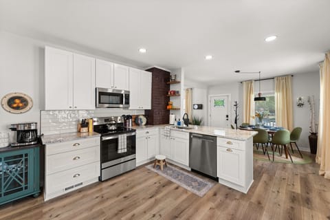 Walking into this kitchen feels like stepping into a Pinterest board - white cabinets and hardwood floors that make you want to cook up a storm in style! 🍳✨