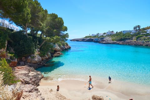 On the beach, white sand, sun loungers, beach umbrellas