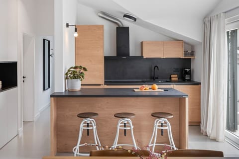 A fully equipped kitchen with a kitchen island and balcony on the second floor