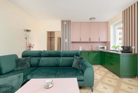 The open living space combines a cozy lounge with a fully equipped kitchenette, perfect for shared morning coffee moments.

