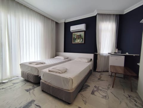 Standard Double or Twin Room, Partial Sea View | Minibar, desk, laptop workspace, free WiFi