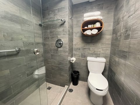 Luxury Room, Courtyard View | Bathroom | Shower, rainfall showerhead, towels, soap