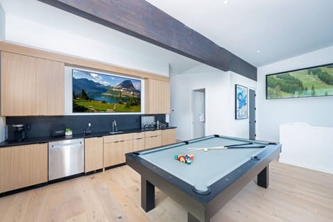 The loft has a pool table and bubble hockey amongst the wet bar and full size living room.