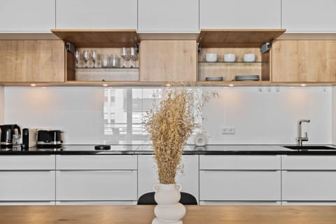 Fully equipped kitchen with sleek cabinetry and high-quality appliances, perfect for preparing your favorite meals.