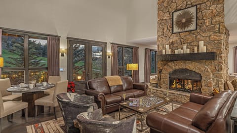 Great room on the main (4th) level with wood fireplace and deck access
