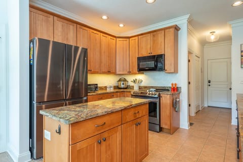 Kitchen with dishwasher, drip-style coffee pot, electric kettle, and breakfast nook
