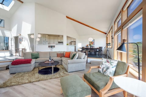 Bright and airy great room, naturally illuminated by the skylights and expansive windows