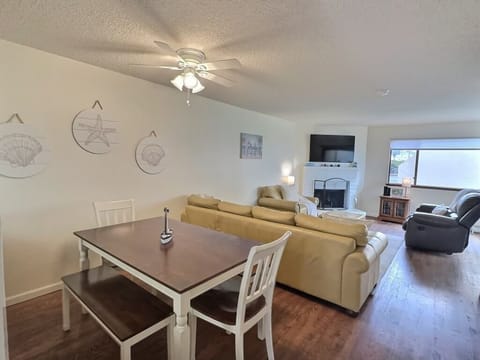 The dining area comfortably seats six guests, perfect for enjoying meals or a game of cards or board games after a day at the beach.