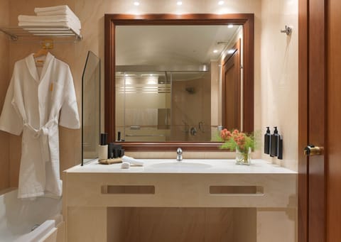 Executive Suite | Bathroom | Hair dryer, slippers, towels, soap