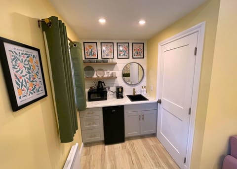 Adorable kitchenette with tasteful dinnerware perfect for light meals.  