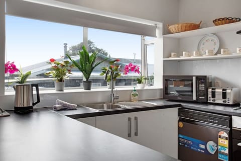 The kitchen has an oven, cook top, microwave, dishwasher, toaster and kettle.