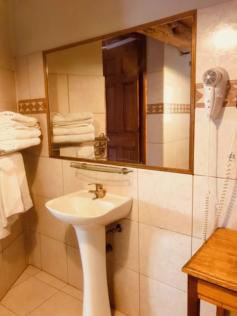 Basic Double Room, Patio | Bathroom | Hair dryer, towels, soap, shampoo