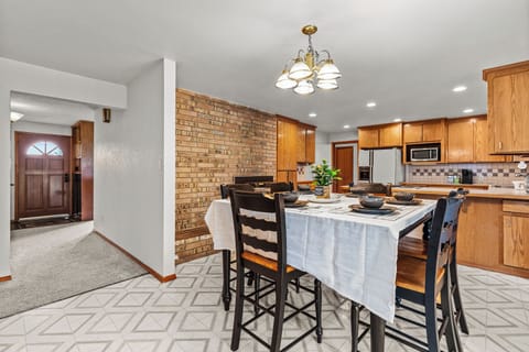 Main door to left with Dining table in front of fully stocked kitchen!