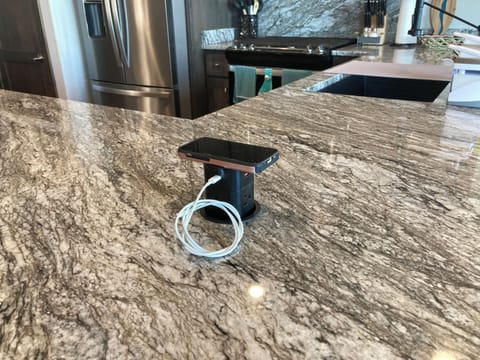 Pop-up phone charger.  Can handle several. Merely push down when not in use.