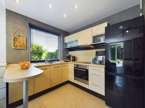 Bright kitchen with cooking utensils. 