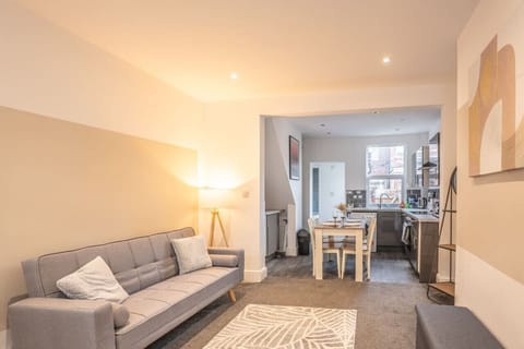 A warm and cosy living room featuring a Smart TV for your entertainment, along with a sofa bed that can be made up for additional guests upon request.